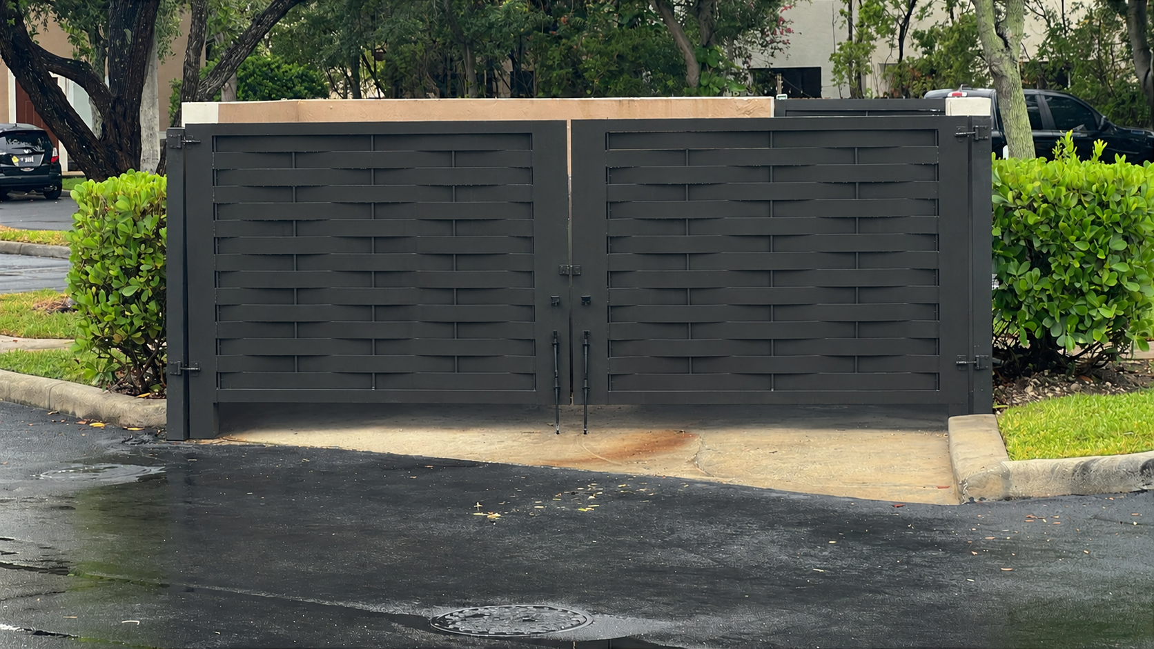 Complete dark charcoal woven-pattern dumpster enclosure fabricated by VIQUI METAL